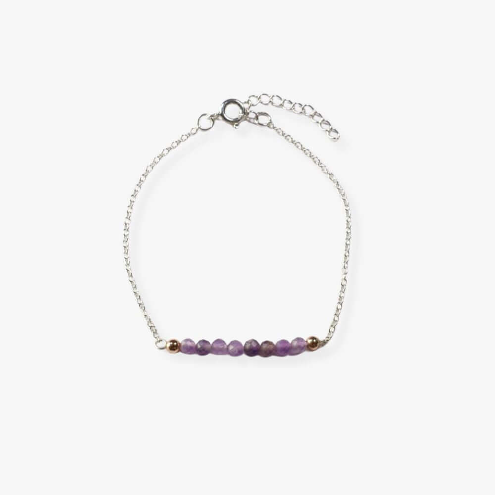 Silver bracelet with Amethyst beads in the middle.
