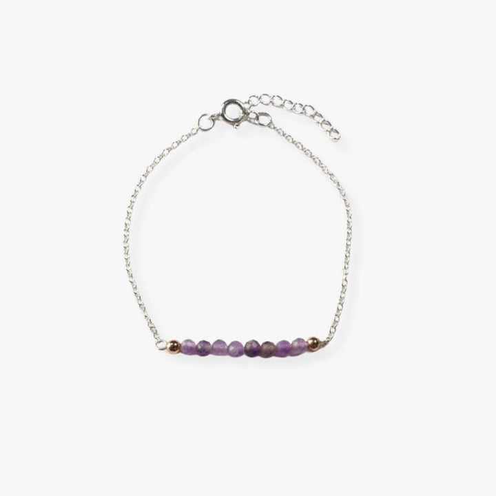 Silver bracelet with Amethyst beads in the middle.