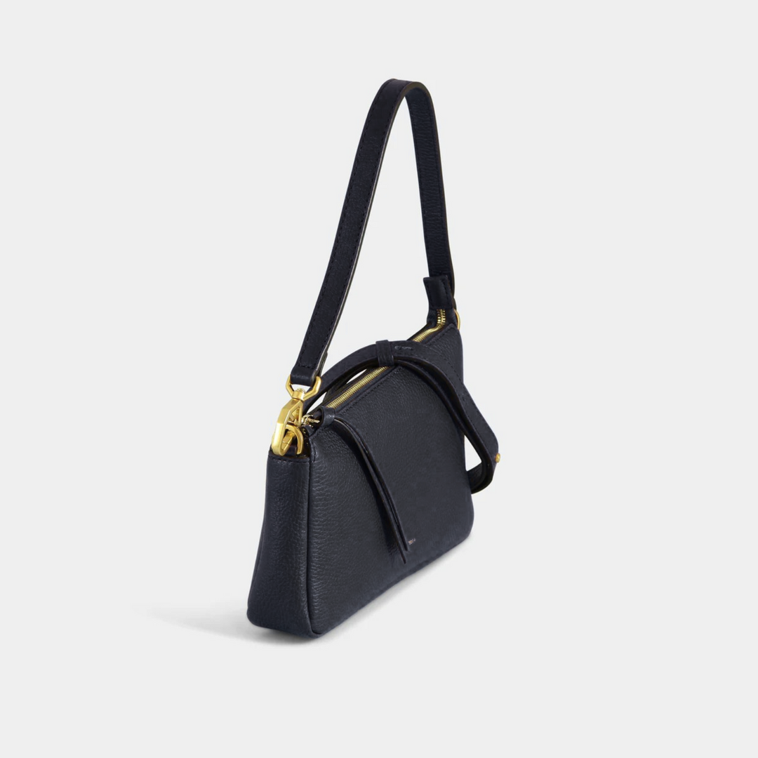 Black pebbled leather shoulder bag with a zip closure. Side view.