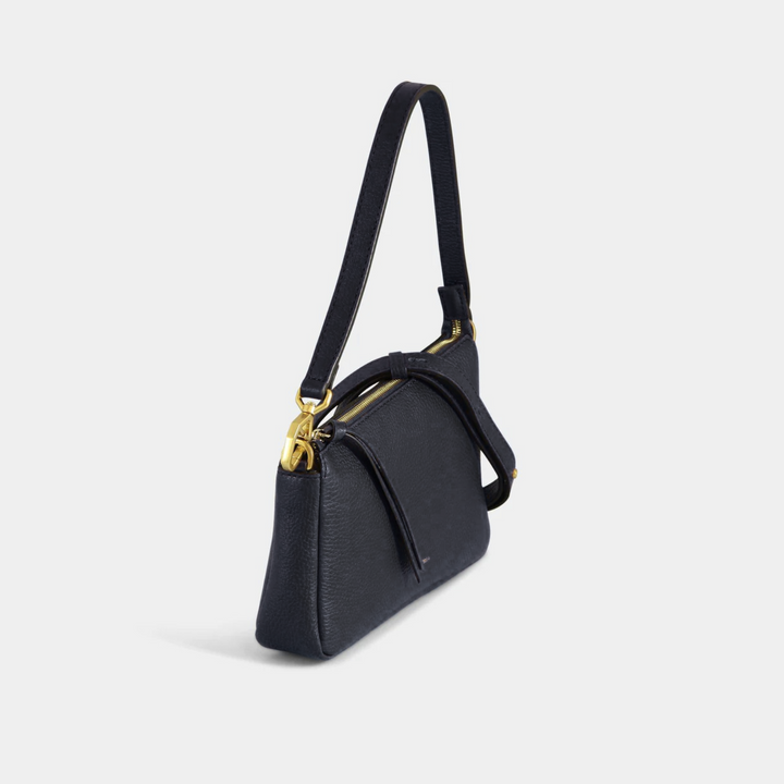 Black pebbled leather shoulder bag with a zip closure. Side view.