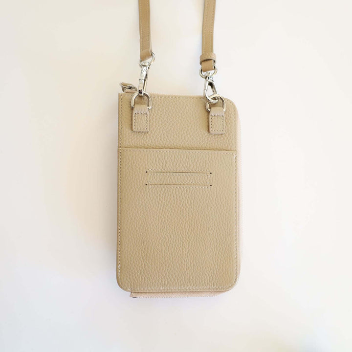 Back of the beige pebbled leather phone crossbody wallet. We can see two card slots and a pocket.