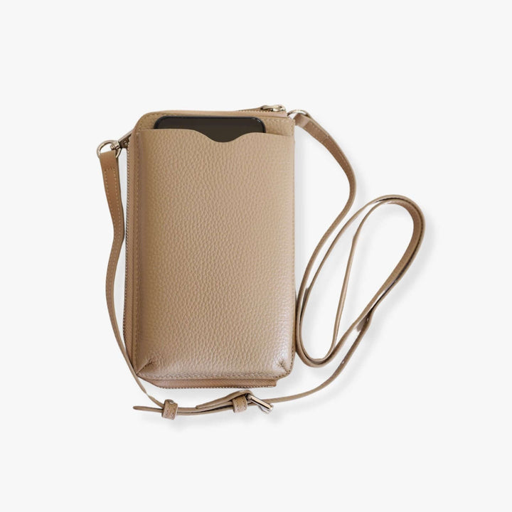 Beige pebbled leather phone crossbody wallet with a black smartphone inside the phone compartment.