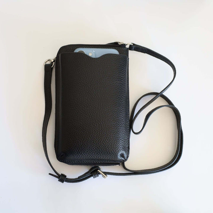 Black pebbled leather phone crossbody wallet with a blue smartphone inside the phone compartment.