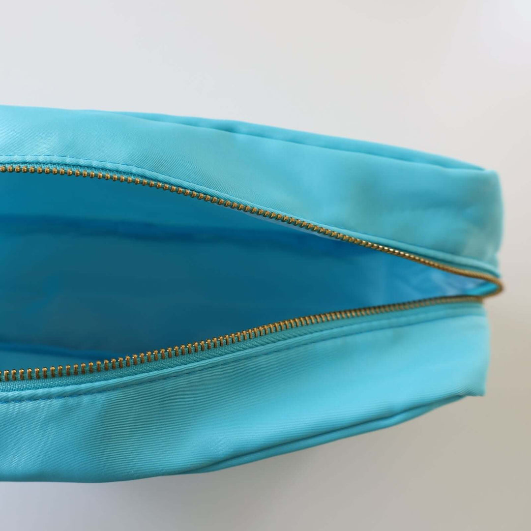 Inside a blue toiletry bag.