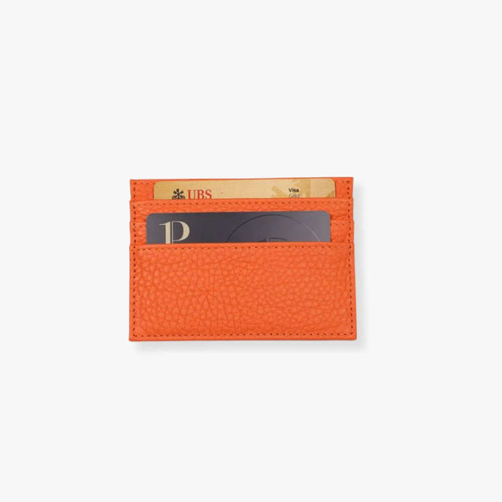 The orange card holder is shown with real credit cards.
