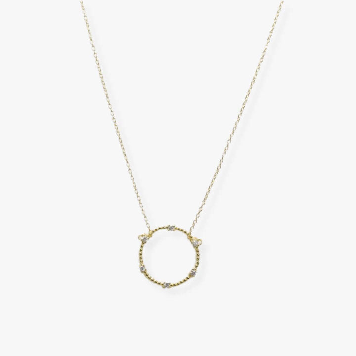Textured 2 cm golden circle suspended from a golden dainty chain