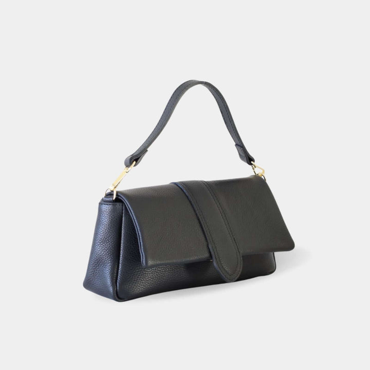 Black pebbled leather handbag with a front flap closure and a top handle attached with gold-tone hardware. Side view.