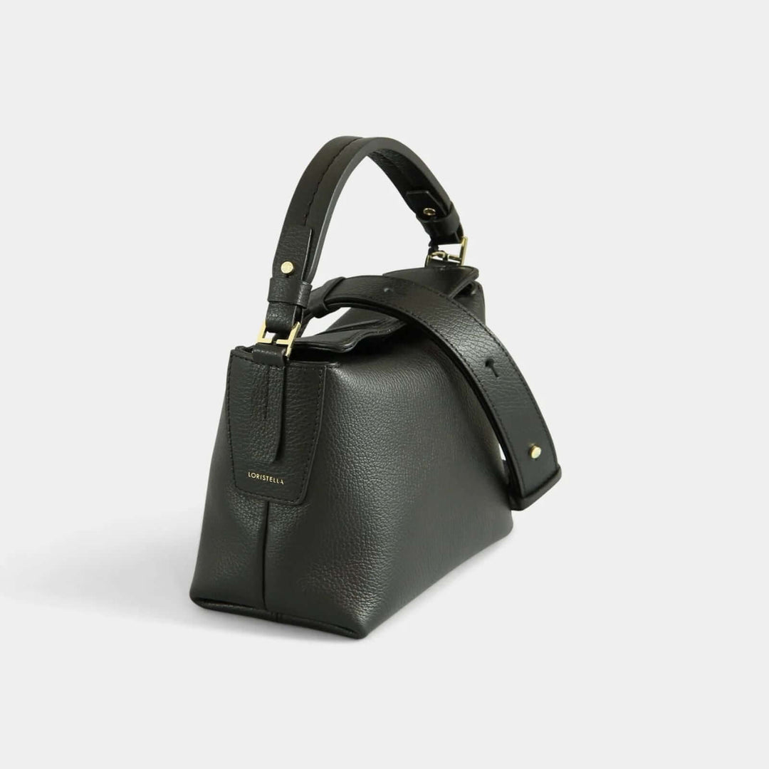 Black pebbled leather crossbody  bag with a small handle. Side view.