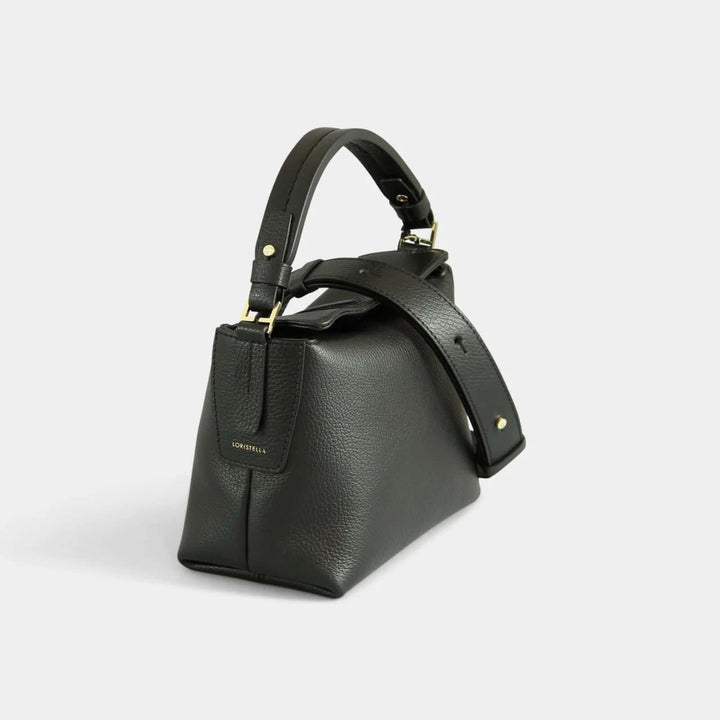 Black pebbled leather crossbody  bag with a small handle. Side view.