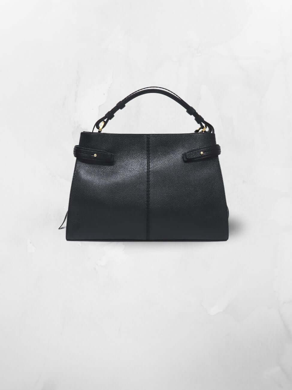 Black leather top handle bag with two tabs on each side adorned with gold-toned studs.