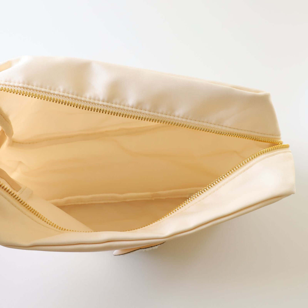 Inside an ivory toiletry bag.