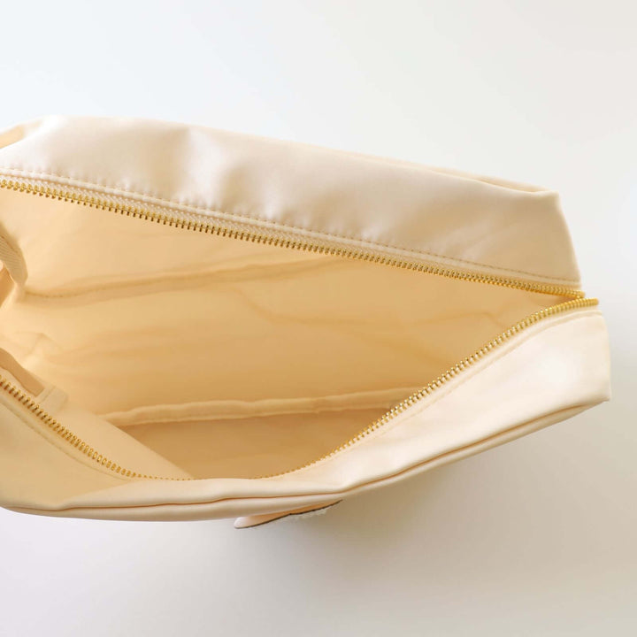 Inside an ivory toiletry bag.
