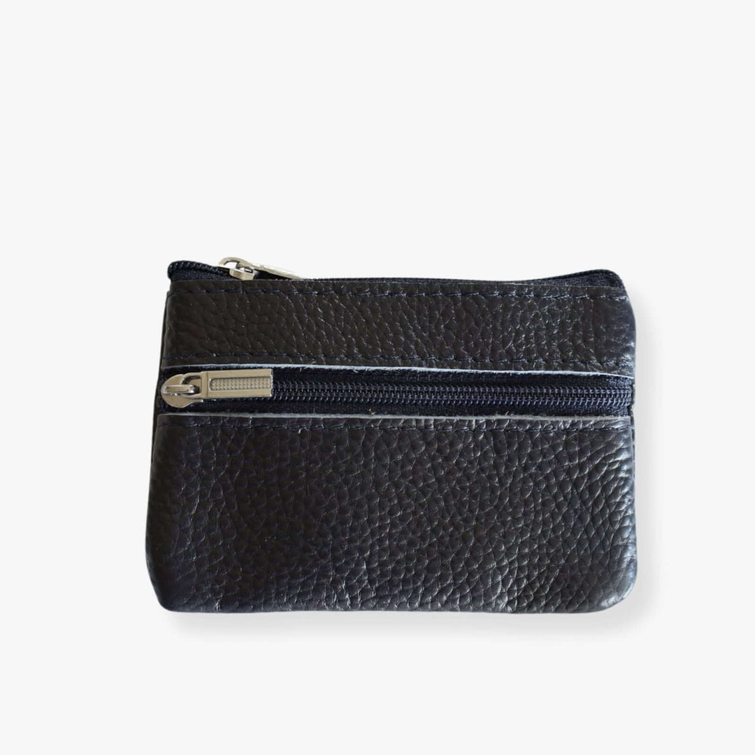 Small blue leather double zipper wallet with an embedded gray metal keychain. the wallet is shown closed.