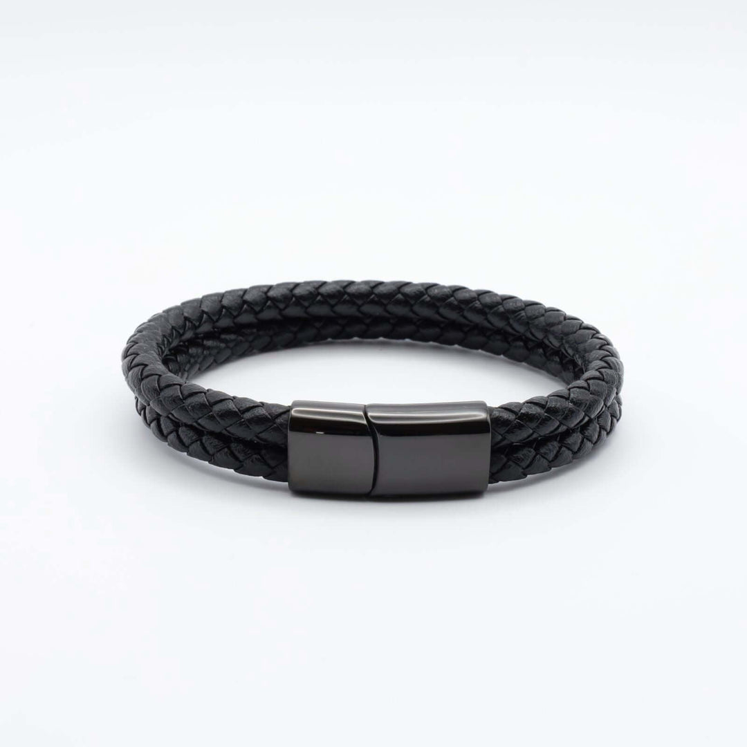 Black braided leather bracelet consisting of two intertwined leather strands and a streamlined black metallic clasp.