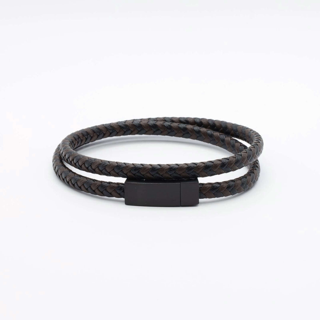 Men's bracelet featuring a double-wrap design crafted from black and brown braided leather. It has a sleek black metal clasp.