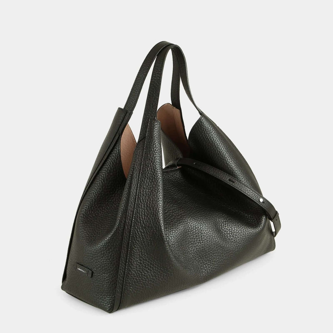 Dual-toned tote bag with a combination of black and brown leather and a detachable shoulder strap. Side view.