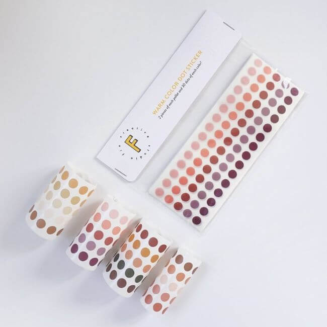 Warm color dot stickers in a plastic bag and in rolls.