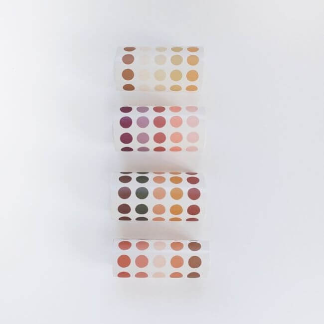 Four rolls of warm color dot stickers.