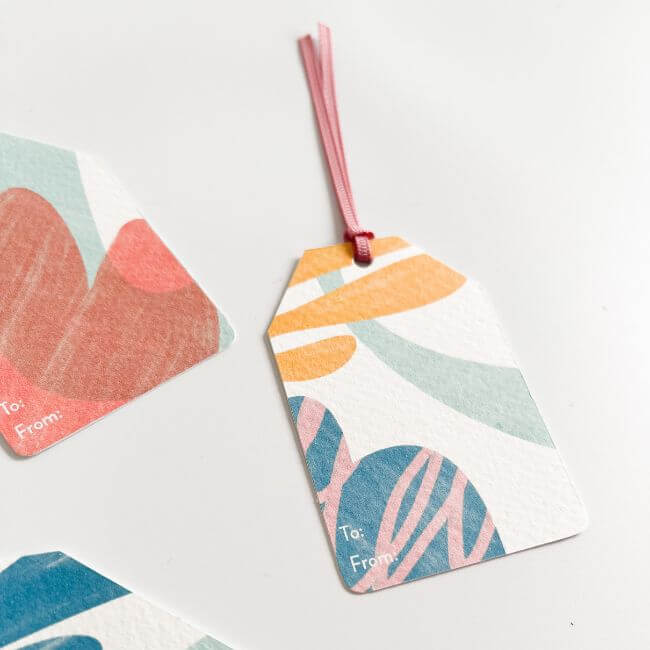 Gift tag with a pink ribbon.