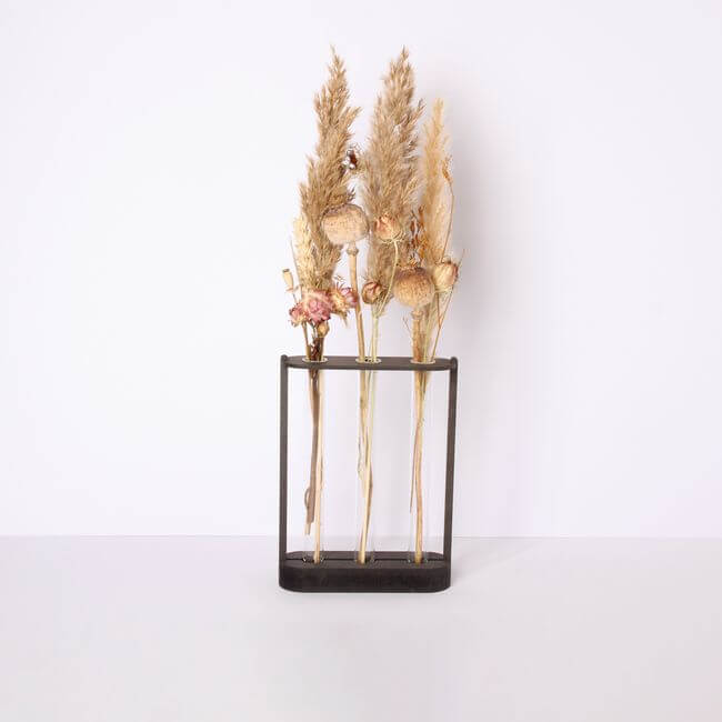 Test tube holder with 3 bud vases holding dried flowers.