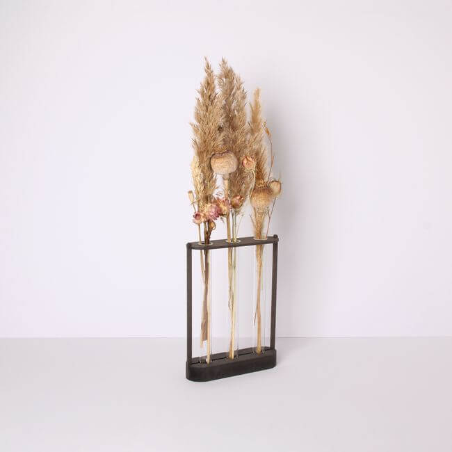 Test tube holder with 3 bud vases holding dried flowers: side view.