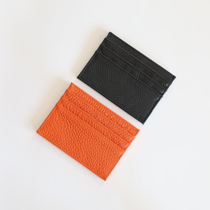 The card holders are offered in black and orange.