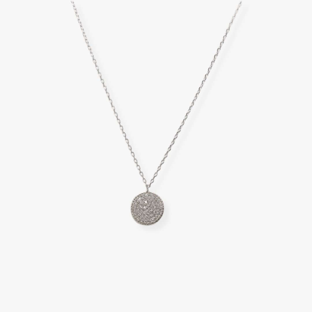 Silver necklace with a disc-shaped pendant set with zirconia.