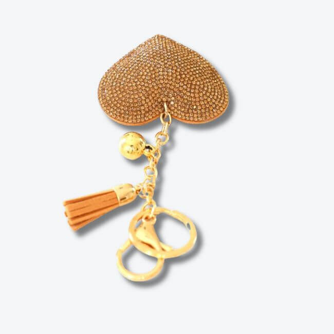 Keychain adorned with a gold rhinestone heart pendant and a faux suede tassel