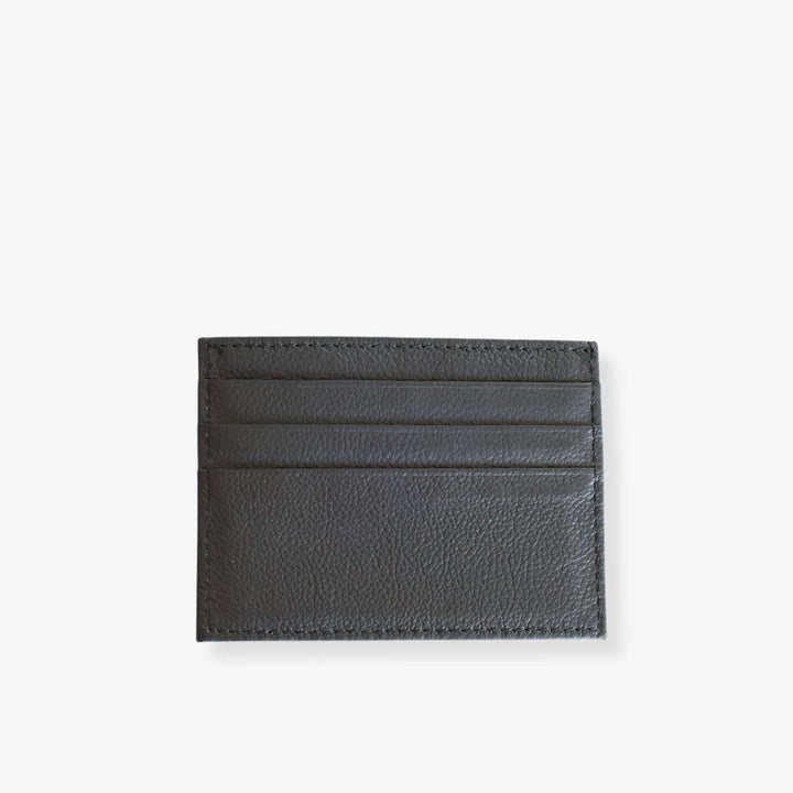 Gray leather card holder with 3 slots on each side.