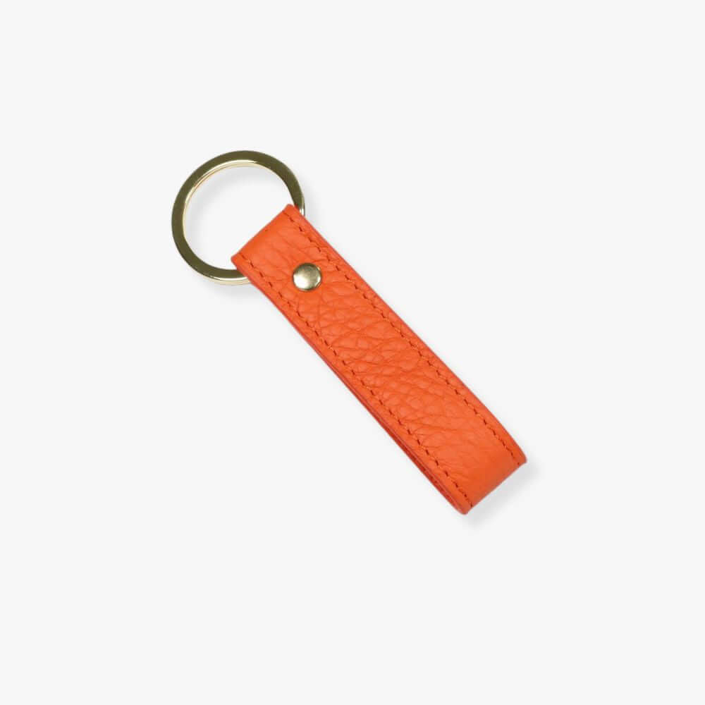 Loop key fob with an orange pebbled leather strap and a golden ring.