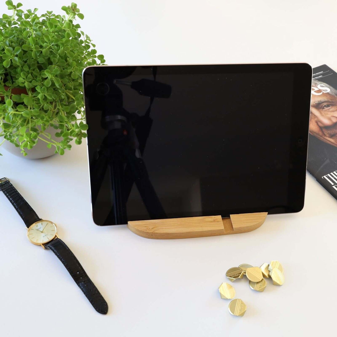 Oval phone and tablet holder holing a tablet horizontally.