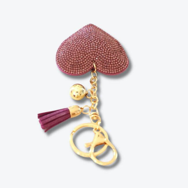 Keychain adorned with a purple rhinestone heart pendant and a faux suede tassel