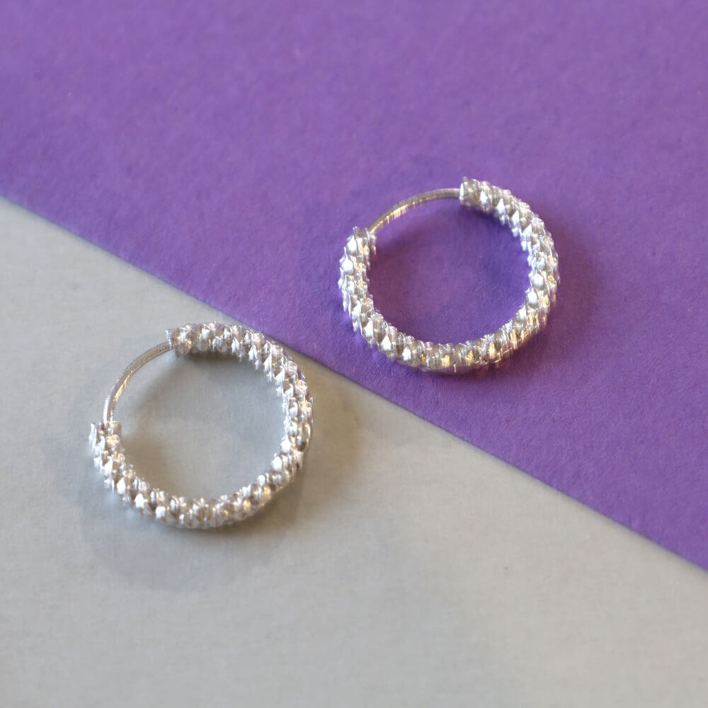 Small silver textured hoop earrings.