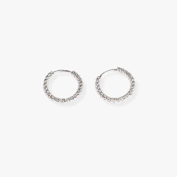 Small silver textured hoop earrings.