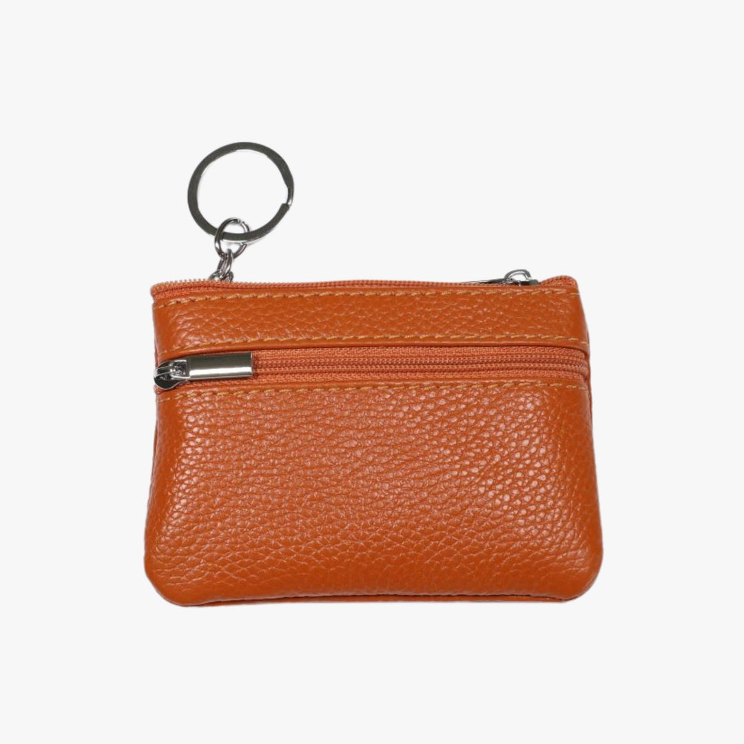 Small tan leather double zipper wallet with an embedded gray metal keychain