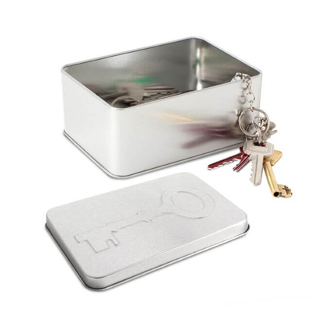 Tin key storage box with open lid.