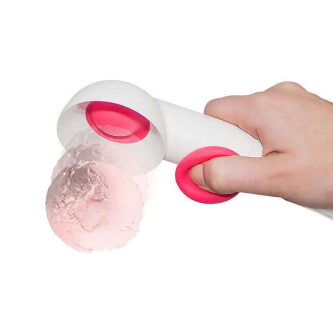 A hand serving pink ice cream with the white ice cream scoop with a pink ball trigger.