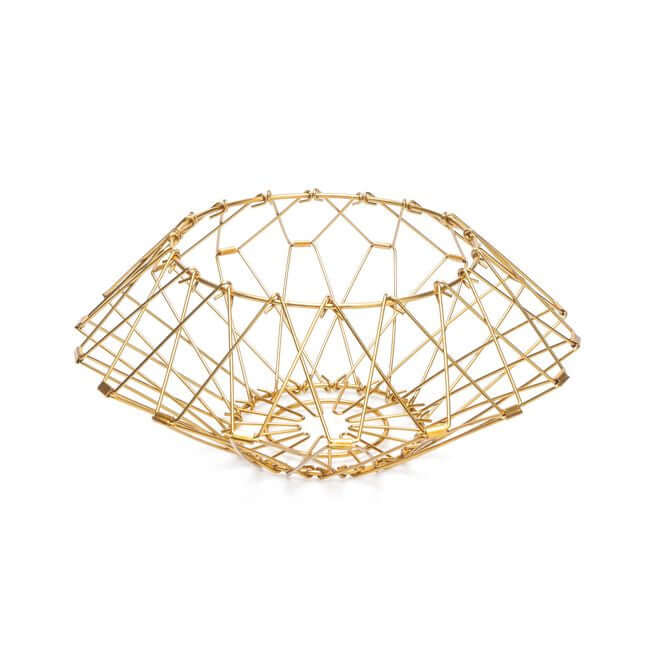 Flexible gold wire fruit basket shaped like a bread basket.