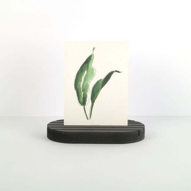 Black card display stand, holding a card with green leaves. The card holder has round edges and 5 slots.