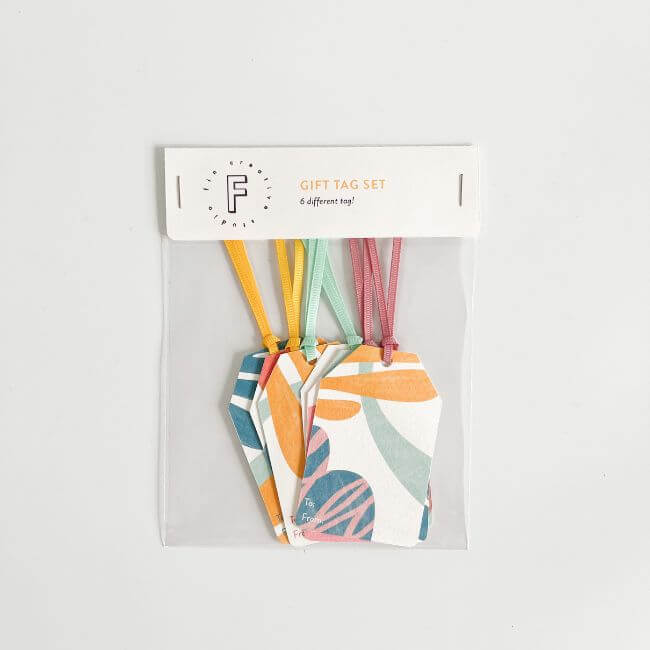 Bag of different gift tags with colorful ribbons.
