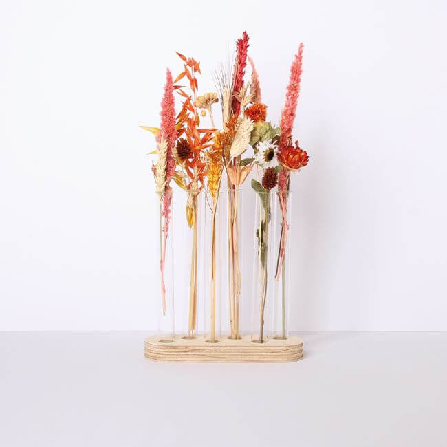 Test tube stand with 6 bud vases and dried plants.